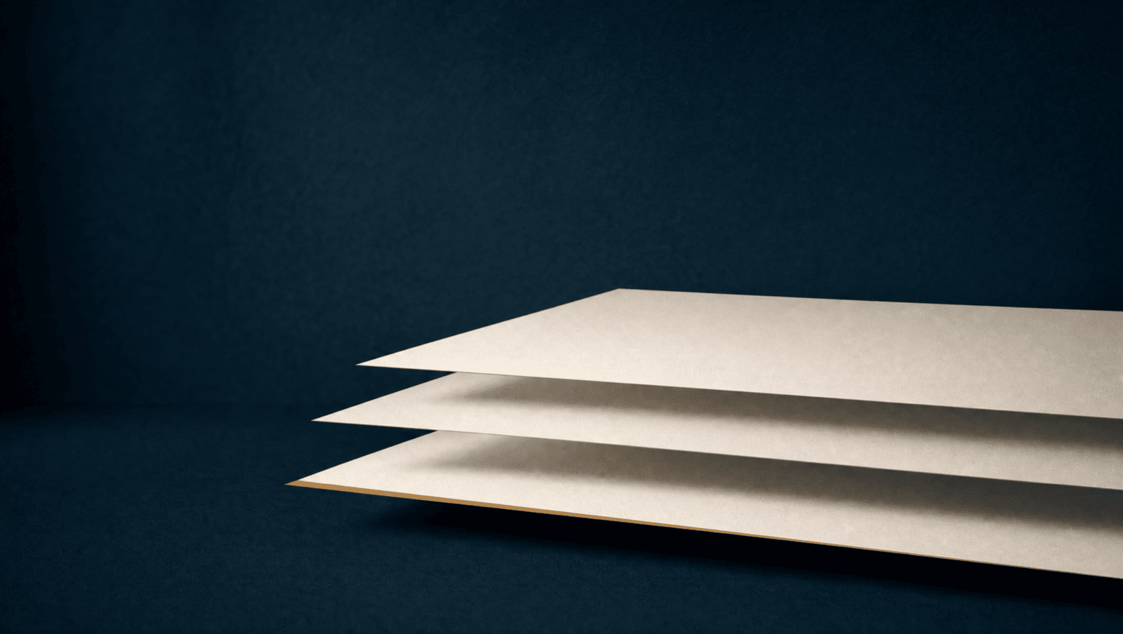 Three offset off-white paper sheets floating over a marine field, catching soft light, with a single warm ochre line tracing the bottom sheet's edge.